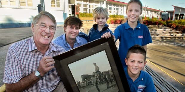 HOLDING HISTORY: Neil Chambers (left) with his son William and grandson George, hand over the historical portrait to the heads of Chambers House, Alice Hoogerbrug and Cooper McDougal, both from Year 6. PHOTO/WARREN BUCKLAND HBT14226901