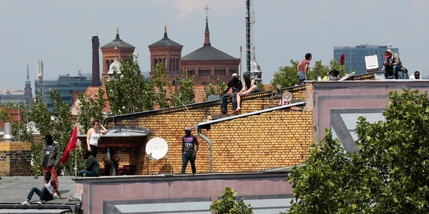 Officials say they'll negotiate, but the migrants must leave the school first. Photo / AP