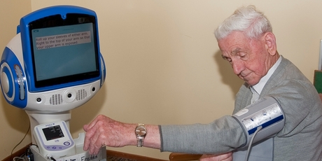 Selwyn Foundation resident Tom Pallas with a health-checker robot - one of several tested at the foundation's two homes in Auckland.