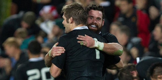 Richie McCaw is hugged by centre Ryan Crotty after their dominant win at Waikato Stadium seals a clean sweep in the series. Photo / Alan Gibson