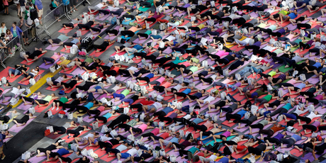 Thousands of New Yorkers are marking the first day of summer by practising yoga in Times Square. Photo / AP