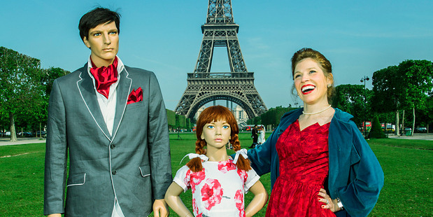 Conceptual Photographer, Suzanne Heintz, poses in front of the Eiffel Tower, one of the world's most iconic tourist destinations with her imitation family. Photo / Suzanne Heintz