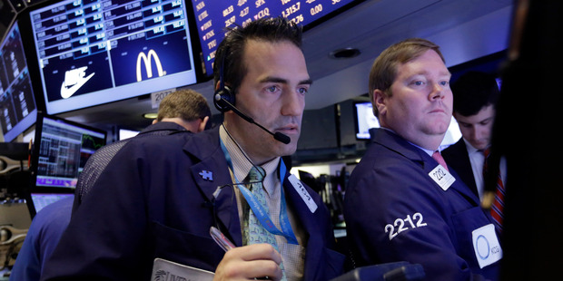 Trader Gregory Rowe, left, works on the floor of the New York Stock Exchange. File photo / AP