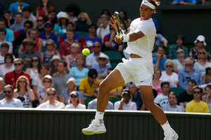 Rafael Nadal of Spain plays a return to Martin Klizan of Slovakia during their match at the All England Lawn Tennis Championships in Wimbledon. (AP Photo/Sang Tan)