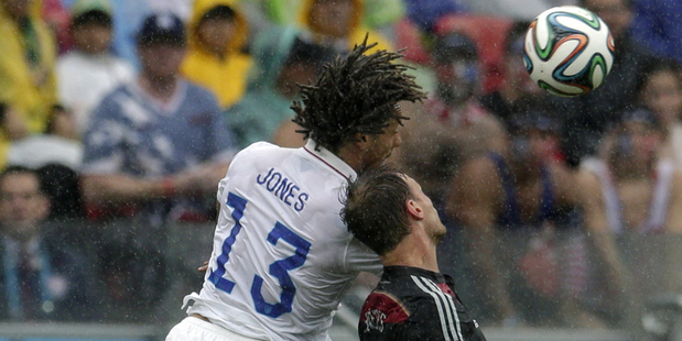 United States' Jermaine Jones, left, and Germany's Benedikt Hoewedes go for a header during their FIFA World Cup match. Photo / AP