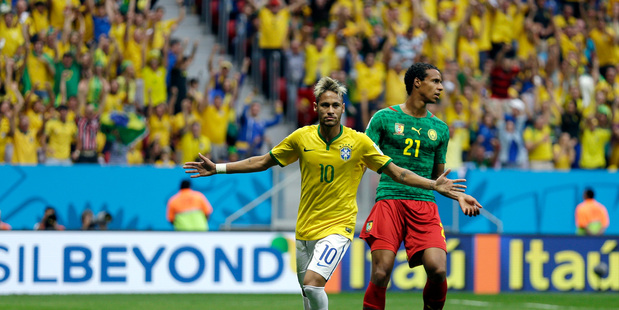 Brazil's Neymar runs past Cameroon's Joel Matip after scoring his side's first goal. Photo / AP