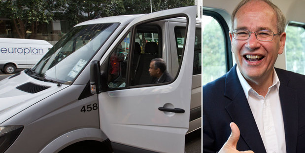 An AT employee gets into an unmarked shuttle on Albert Street. Right, Len Brown at the launch of Auckland's electric train service. Photo / NZ Herald