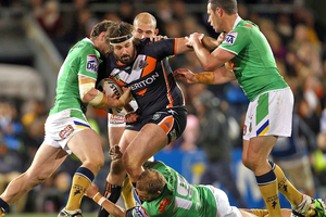 Aaron Woods of the Tigers is tackled by the Raiders defence. Photo / Getty Images