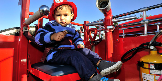 Tamariki Day Festival at the Arataki Community Centre. Carlos Heyes, 2, has a ride on the fire truck. PHOTO/GEORGE NOVAK