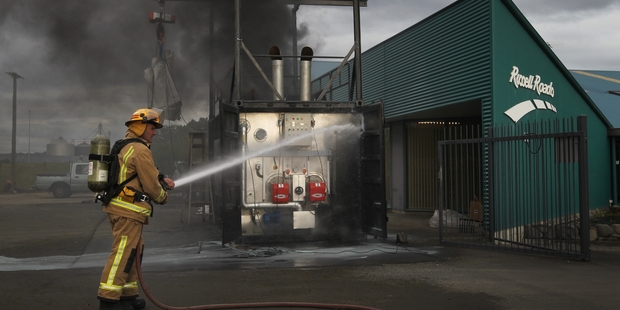 A fireman grapples with the fire yesterday in a new bitumen plant parked at Russell Roads. Photo/Duncan Brown