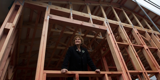 Sue Gunn admires the progress of the second house to be built over five years as part of a project to raise funds for local charities. Photo/Stephen Parker
