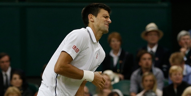 Novak Djokovic grimaces as pain shoots through his left shoulder before bouncing back to topple Jo-Wilfried Tsonga in straight sets yesterday. Photo / AP
