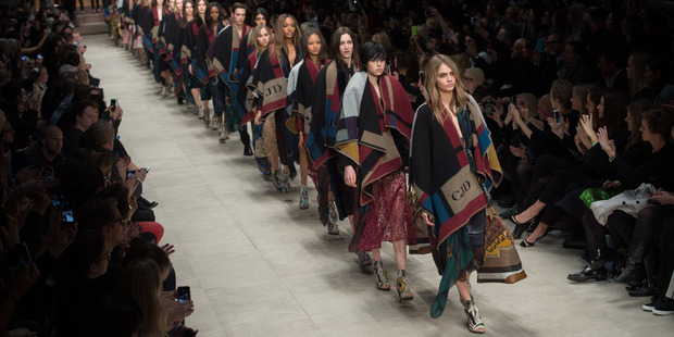 Models including Cara Delevingne wore personalised ponchos at Burberry Prorsum. Photo / Getty Images.