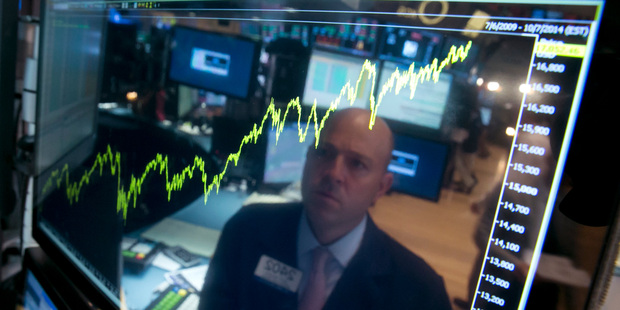 Specialist Jay Woods at his post that shows five years of the Dow Jones industrial average, on the floor of the NYSE. The Dow closed above 17,000 for the first time last week, but dropped overnight.. Photo / AP