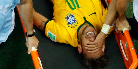 Brazil's Neymar is carried away after getting injured. Photo / AP
