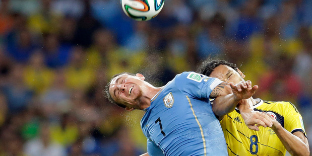 Uruguay's Cristian Rodriguez, left, and Colombia's Abel Aguilar go for a header during their World Cup round of 16 soccer match at Maracana Stadium in Rio de Janeiro. Photo / ap