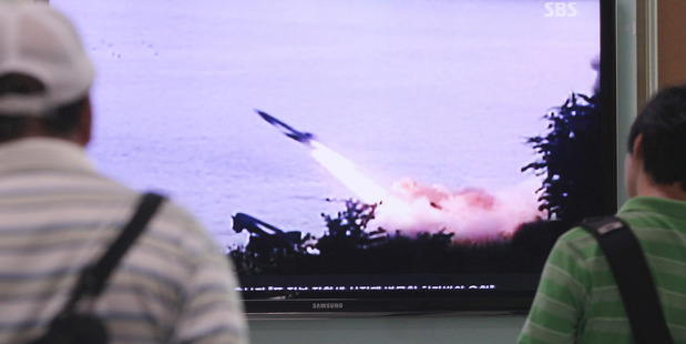 File photo of people watching a TV news program showing the missile launch conducted by North Korea, at Seoul Railway Station in Seoul. Photo / AP