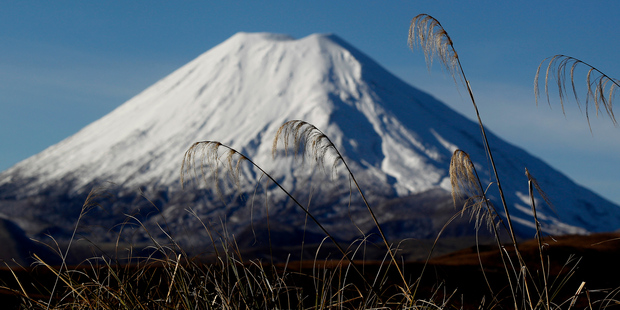 A snow-capped Mt Ngauruhoe makes a stunning backdrop for a journey through the central North Island. Photo / Christine Cornege