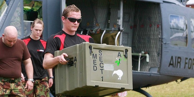 NZ Defence Force personnel unload medical supplies to treat villagers after a tsunami. Photo / APN
