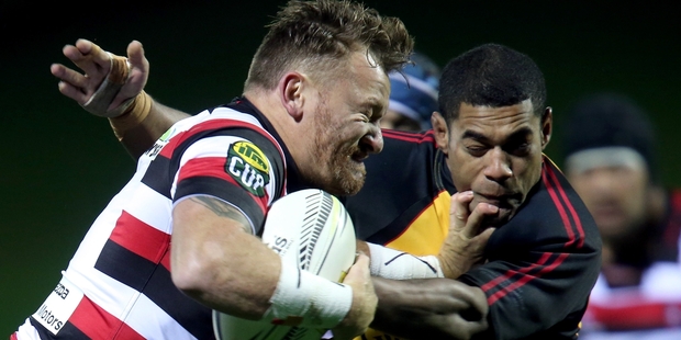 Counties Manukau halfback Kane Hancy fends off Wliiiam Tamanalevu last night. Photo / Getty Images