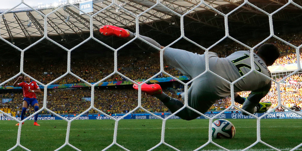 Brazil's goalkeeper Julio Cesar saves Alexis Sanchez's penalty shot in the shoot-out. Photo / AP.