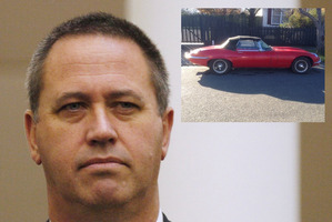 Michael Swann and the E-Type jaguar sports car he is thought to be linked to.