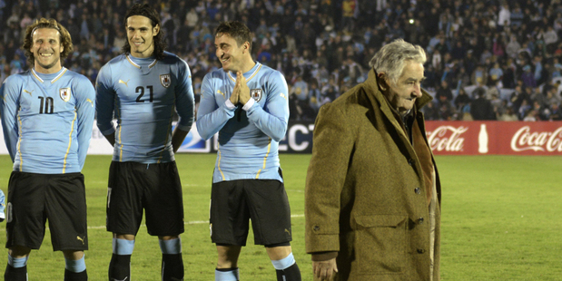 Uruguay's President Jose Mujica, right, leaves the field before a Uruguay game earlier in the year. Photo / AP