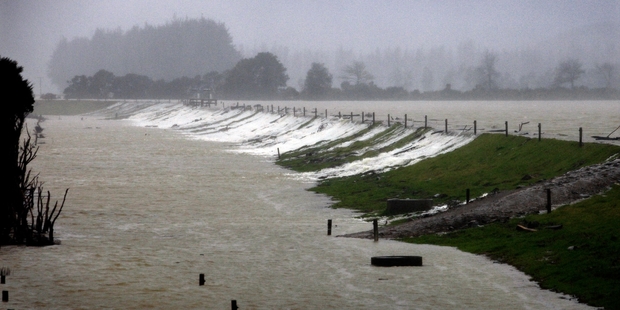 Stop banks on Jordan Valley Rd couldn't contain all the water that flowed into the Hikurangi Swamp yesterday. Photo / Tania Newman