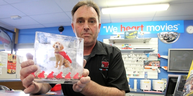 Kevin Knox, owner of Video Ezy Greenmeadows, Napier, with a charity donation box for the Royal New Zealand Foundation for the Blind, which a Video Ezy member allegedly tried to steal at the weekend. He was thwarted by the Velcro dots attaching the box to the counter. Photo/Duncan Brown