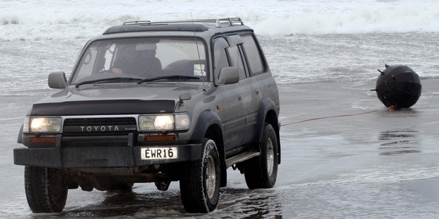 After being declared non-explosive, the mine was towed up the beach and taken to the police station. Photo / Tania Newman
