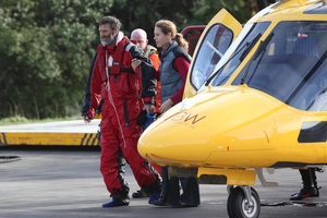 Scott Donaldson walks from the rescue helicopter yesterday with his wife, Sarah. Photo / Glenn Jeffrey