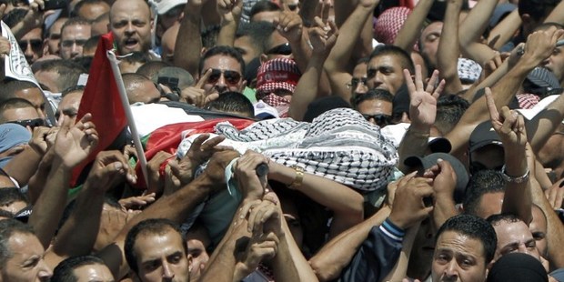 Relatives and friends of Mohammed Abu Khder, 16, carry his body to the mosque during his funerals in Shuafat, in israeli annexed East Jerusalem. Photo / AP