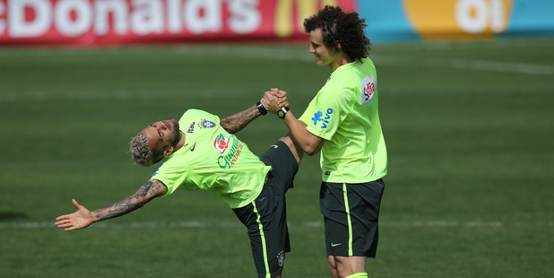 Brazil's Daniel Alves, left, stretches with David Luiz during a practice session at the Granja Comary training center, in Teresopolis, Brazil. Photo / AP