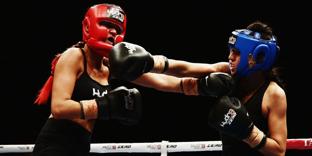 Girls from The GC, Jade Louise, left, and DJ Tuini, battle it out at the boxing night at the Vodafone Events Centre last night. Photo / Getty Images