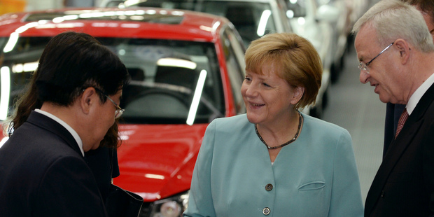 German Chancellor Angela Merkel, chats with FAW Group President Xu Jianyi, left, and Volkswagen CEO Martin Winterkorn, right, as they visit the FAW-Volkswagen production plant in Chengdu. Photo / AP