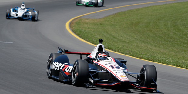 Will Power (12), of Australia, leads a group of race cars out of turn three during the Pocono IndyCar 500 race. Photo / AP