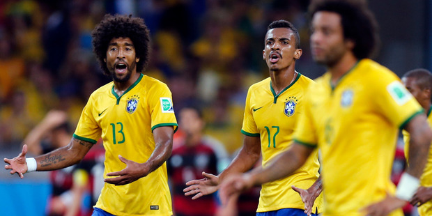 Brazil's Dante, left, and Luiz Gustavo react after Germany scored during the World Cup semifinal soccer match between Brazil and Germany at the Mineirao Stadium in Belo Horizonte. Photo / AP