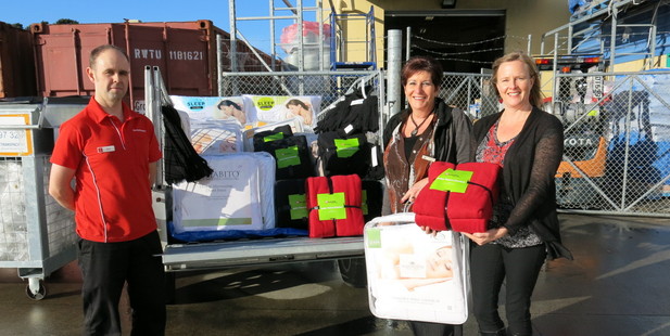 Papamoa Warehouse sales manager Matt Orsborn has supervised the packing of a trailer full of "winter warmers" for the benefit of Beachaven Anglican Care clients. Family advocate Gale Gordon, centre, and counsellor Naarah Simpson collected the trailer last Wednesday, to deliver the goods to needy families.