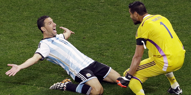 Argentina's Maxi Rodriguez celebrates with goalkeeper Sergio Romero after scoring the last penalty. Photo / AP