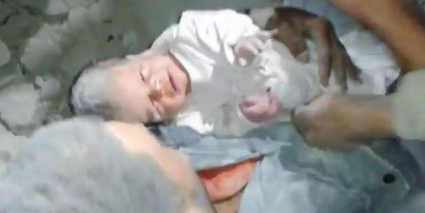 Video footage shows a baby being rescued from the rubble in Syria.