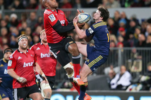 Nemani Nadolo and Richard Buckman compete for a high ball during the Crusaders' win over the Highlanders. Photo / Getty
