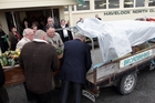 Pallbearers prepare Rex Flanders for his final ride yesterday, on the back of the old Mazda ute which he sold fruit and vegetables from for many years.Photo/Paul Taylor Pallbearers prepare Rex Flanders for his final ride yesterday, on the back of the old Mazda ute which he sold fruit and vegetables from for many years.Photo/Paul Taylor