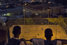 Two boys watch kids play pelada at the Mangueira slum in Rio de Janeiro, Brazil. Photo / AP Two boys watch kids play pelada at the Mangueira slum in Rio de Janeiro, Brazil. Photo / AP