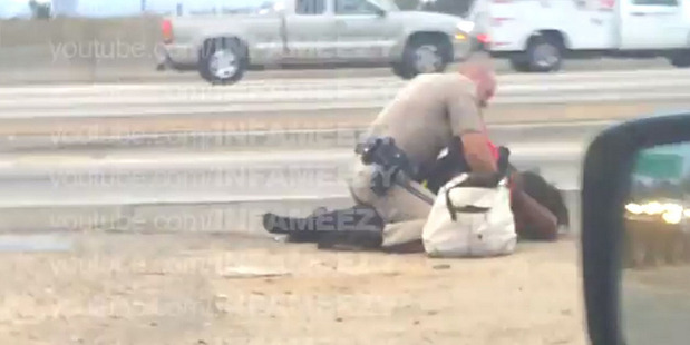 Footage captured by a passer-by shows a California Highway Patrol officer assaulting a woman.