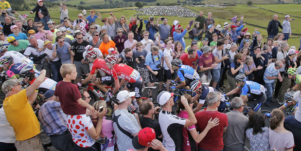 Fans get close to the riders during the second stage of the Tour de France in England. Photo / AP