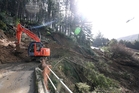 Whangarei District Council contractors work on clearing a large slip on Takitu Rd, north west of Whangarei, yesterday that has blocked access to four homes.Photo/Michael Cunningham Whangarei District Council contractors work on clearing a large slip on Takitu Rd, north west of Whangarei, yesterday that has blocked access to four homes.Photo/Michael Cunningham