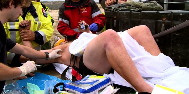 Todd Mullinder, being treated, says he was in so much pain after his accident he tried to kick medics working to save him.
