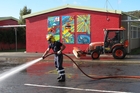 Whangarei firefighter Glenn Stodart hoses down the carpark at Moerewa School yesterday. Photo/Peter de Graaf Whangarei firefighter Glenn Stodart hoses down the carpark at Moerewa School yesterday. Photo/Peter de Graaf