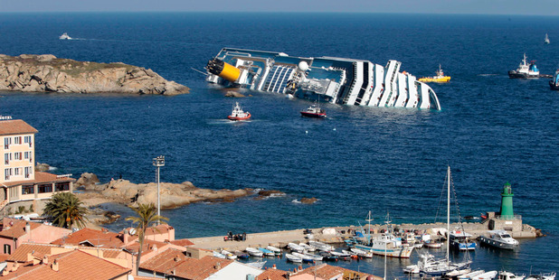 The luxury cruise ship Costa Concordia leaning on its starboard side after running aground. Photo / File / AP