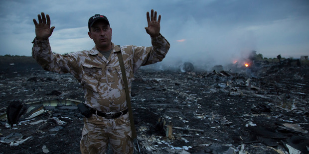 A man gestures at the crash site near the village of Grabovo, Ukraine. Photo / AP